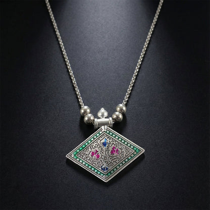Ethnic oxidised silver finish pendant necklace displayed on white background