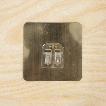 Adhesive wall hook on metal surface for home organization