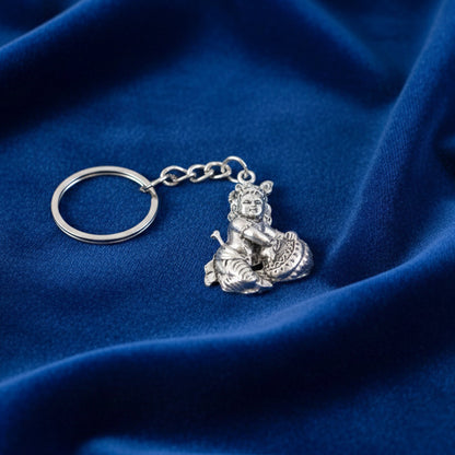 Detailed front-facing view of silver Bal Krishna Makhan Chor keychain