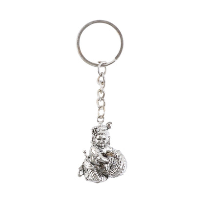 Bal Krishna Makhan Chor keychain displayed against a wooden backdrop