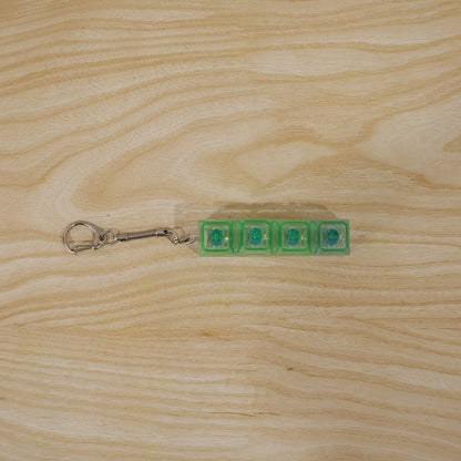 Small gadget key holder with tactile click and LED glow