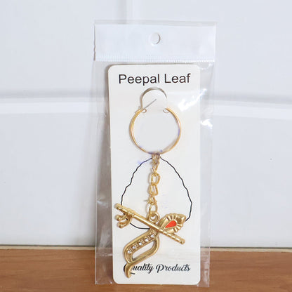Multiple Krishna metal keychains placed on flat surface, showing consistent design quality