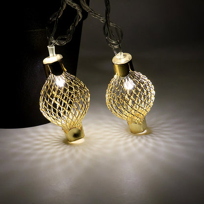 LED string light draped on home decor featuring golden metal balls