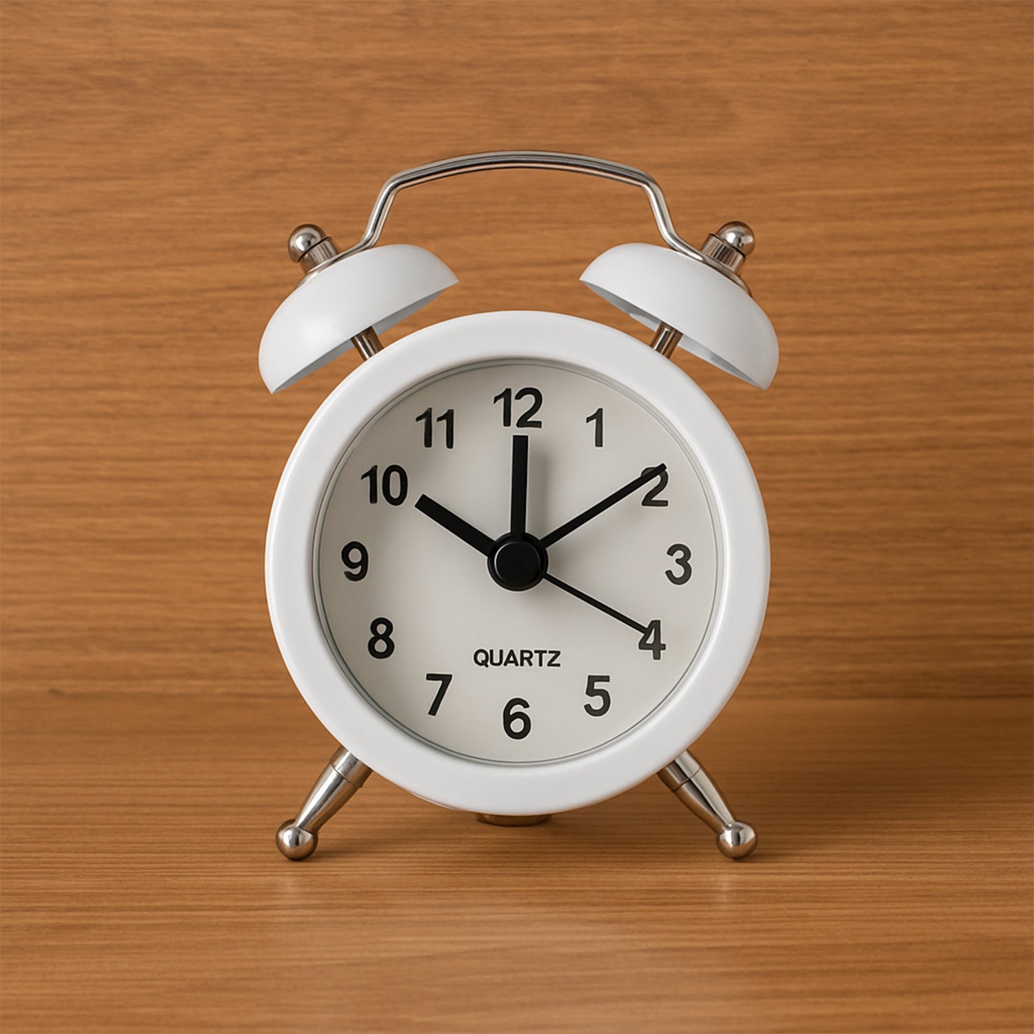 Close-up of a classic twin-bell analog alarm clock face.