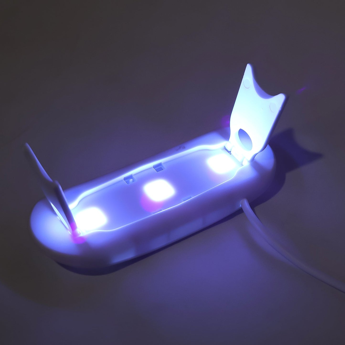 Travel-friendly UV LED nail dryer with foldable stand