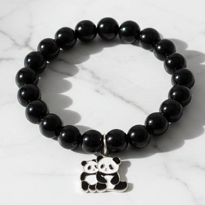 Black beaded stretch bracelet with an adorable panda charm on white background.