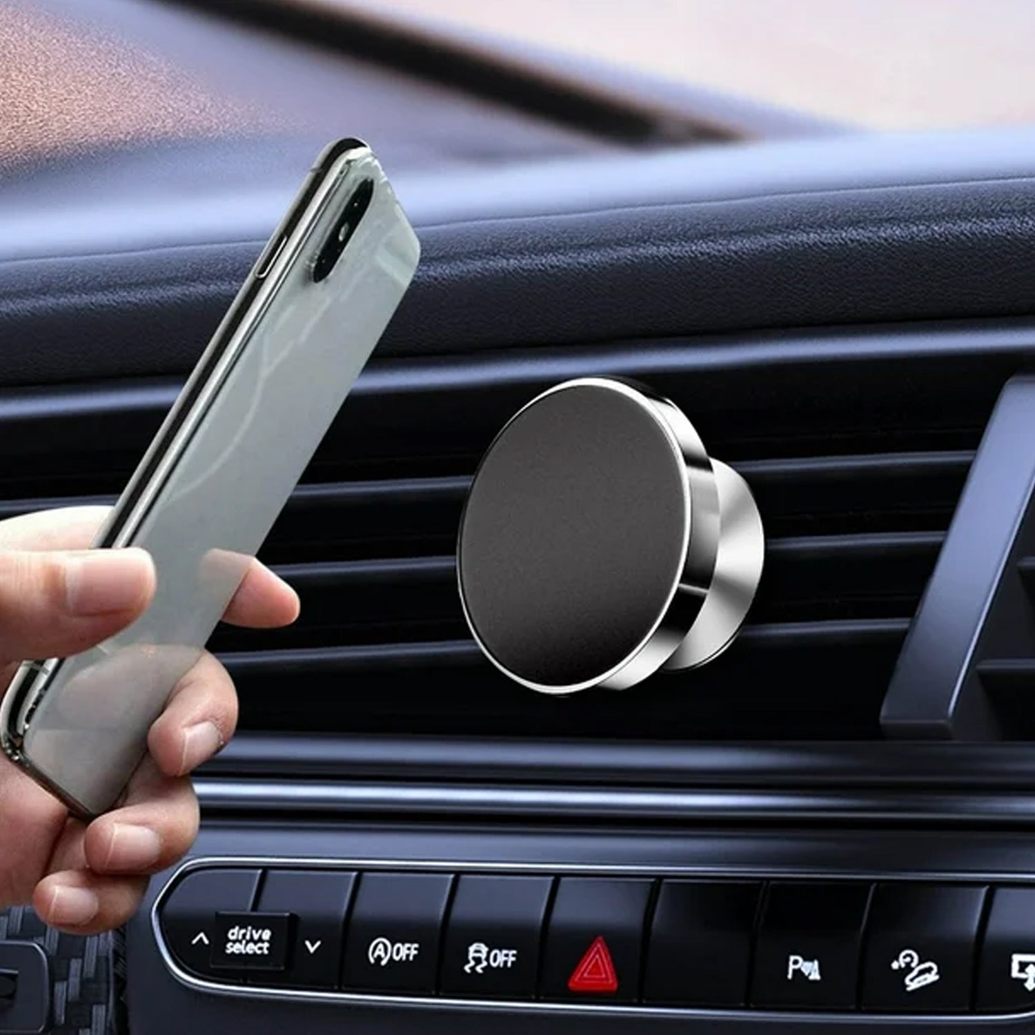 Smartphone held securely on car dashboard by magnetic phone holder