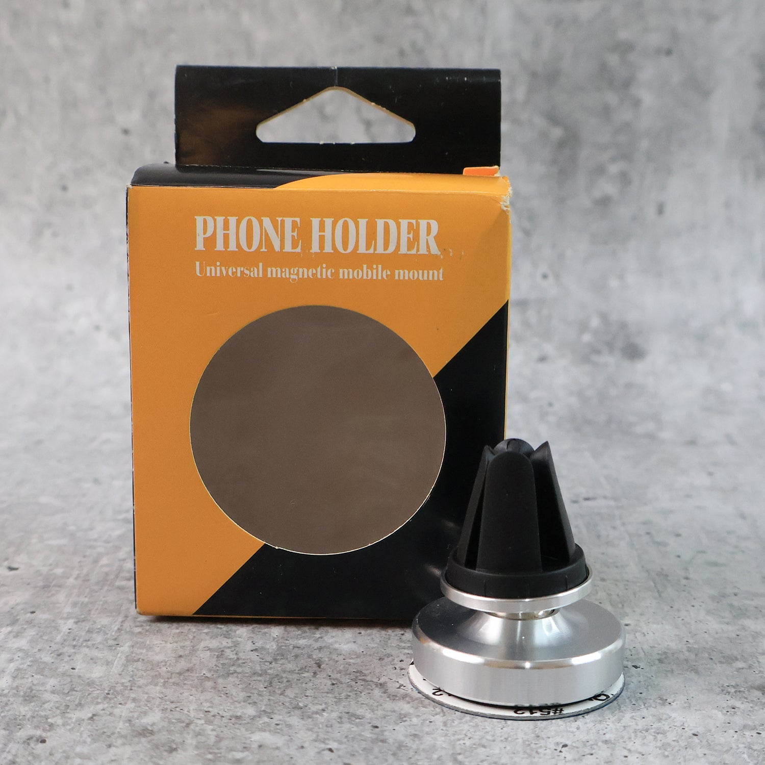 Rotating magnetic phone holder securing smartphone on car dashboard