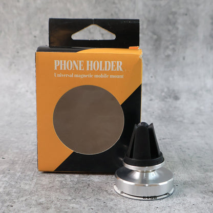 Rotating magnetic phone holder securing smartphone on car dashboard