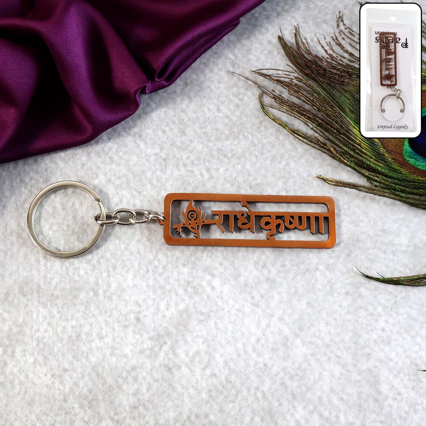 Radha Krishna Metal Keychain with laser-cut Hindi inscription and peacock feather motif