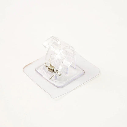 Self-adhesive curtain rail clip installed on wall for lightweight curtains