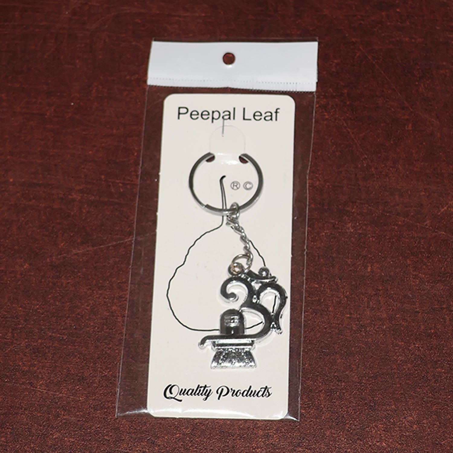Spiritual metal keychain featuring Om symbol and Shivling icon