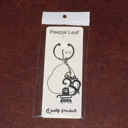Spiritual metal keychain featuring Om symbol and Shivling icon
