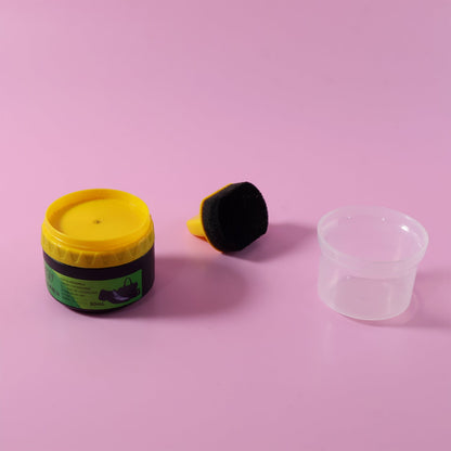 Black shoe polish cream container shown with open lid