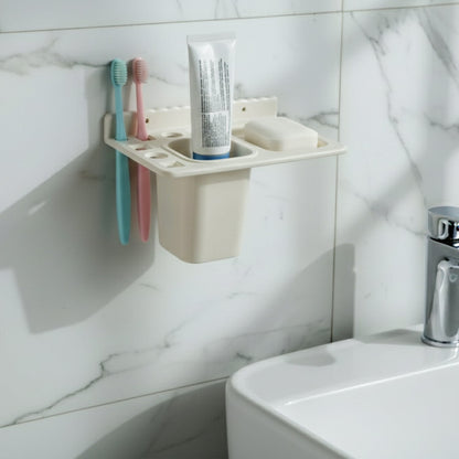 Soap tray with drainage holes in the wall mounted toothbrush holder keeping soap dry.