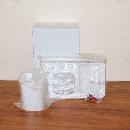 Lifestyle image of wall mounted toothbrush holder with toothbrush and toothpaste inside.
