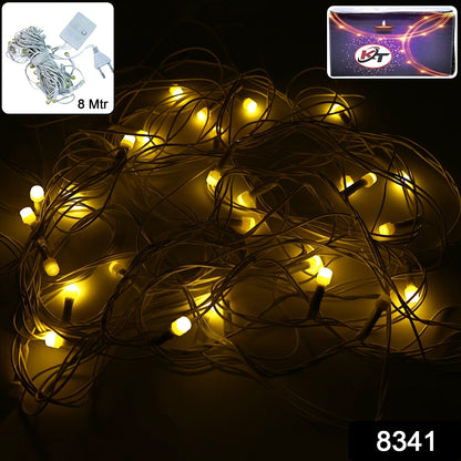 Close-up view of warm white fairy lights on flexible wire