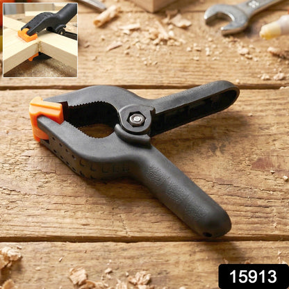 Close-up of a heavy duty spring clamp holding materials firmly