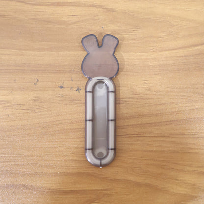 Self stick push pull helper shown firmly attached to cabinet surface