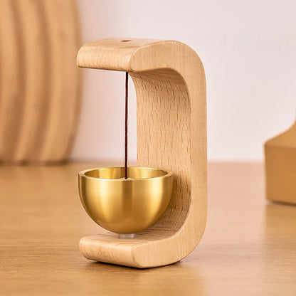 Detailed view of wooden stand and brass chime ball of Zen bell