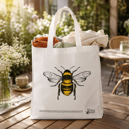 Outdoor garden scene with bee print tote bag
