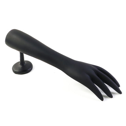 Jewelry pieces displayed elegantly on black hand-shaped stand