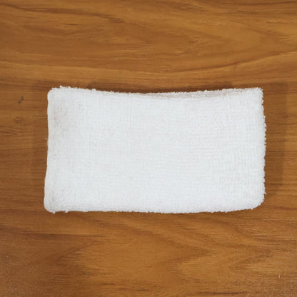 Person cleaning wooden furniture surface with microfiber cloth