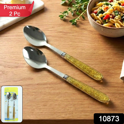 Close-up of two glitter handle stainless steel spoons in the dining set