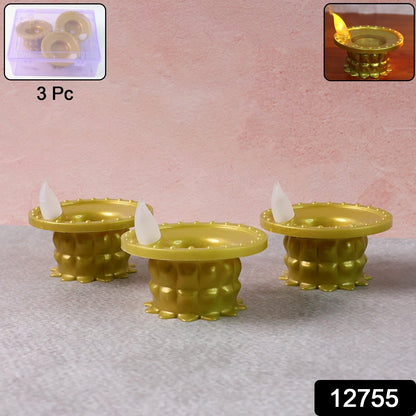 Golden water sensor LED diyas glowing in a decorative arrangement.