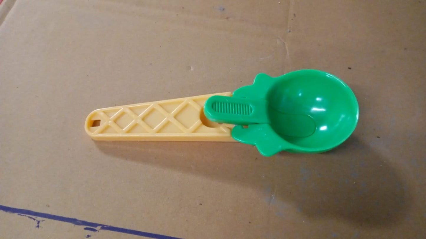 Kitchen setup featuring plastic ice cream scooper with trigger