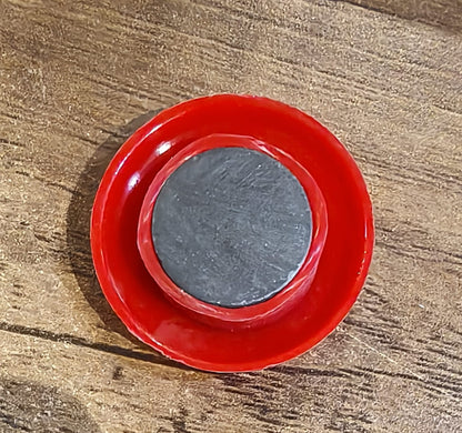 Arrangement of red magnetic buttons on a magnetic office board