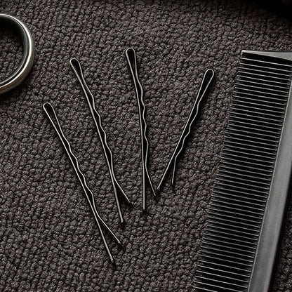 Detailed close-up of black bobby pin with smooth tips