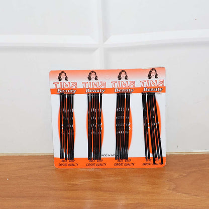 Lifestyle image of black hair bobby pins used in an elegant bun hairstyle