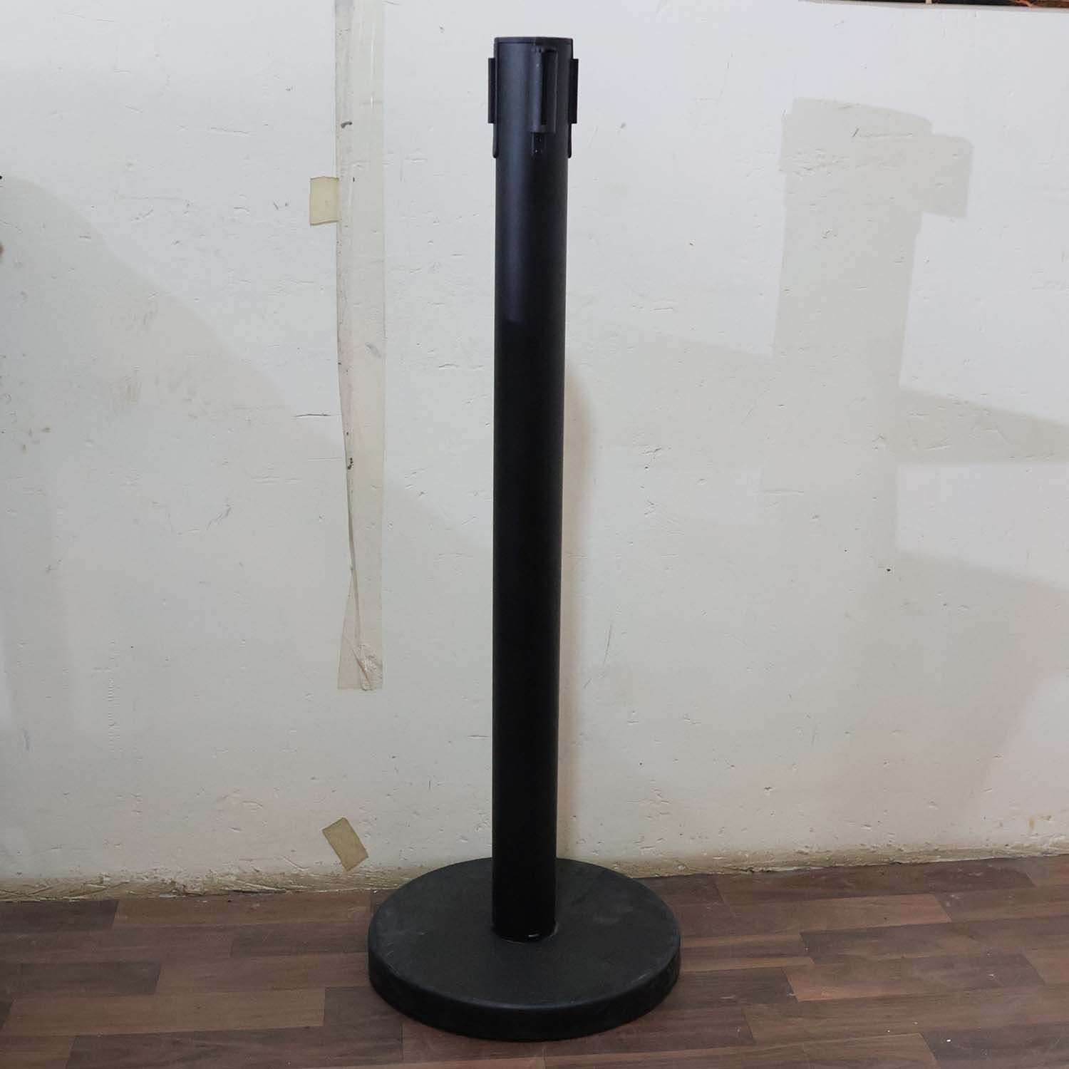 Crowd control pole with retractable belt in use at event venue